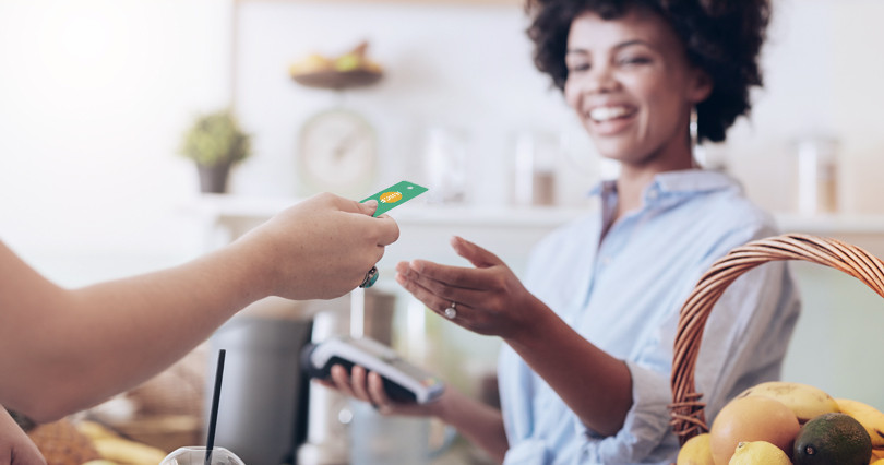 A women reaches her hand out to grab her card.