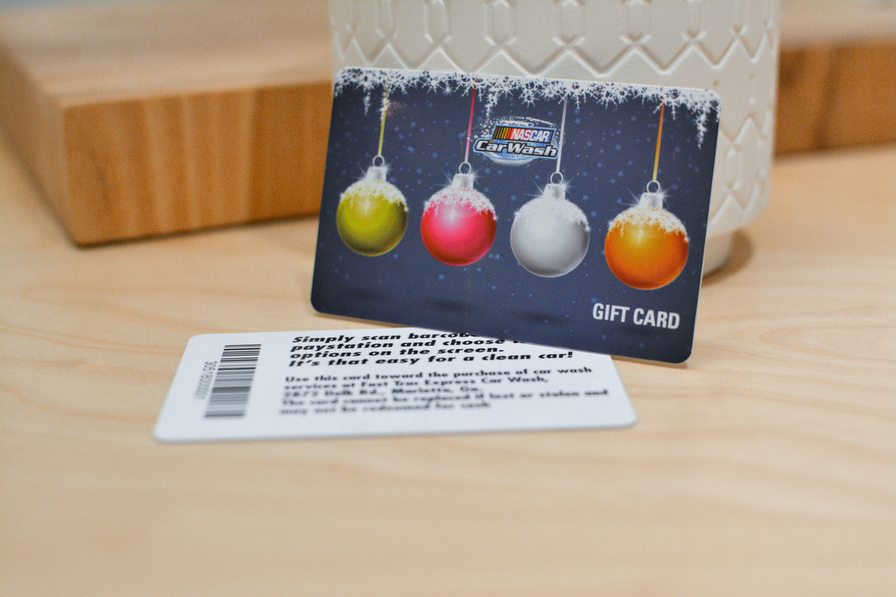 Two cards showing the front and back of a plastic gift card with a winter holiday design