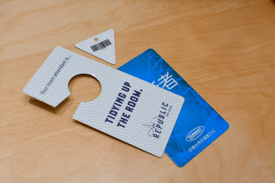 Three different custom plastic cards including a door hanger, an ID card, and a custom cut triangular key tag