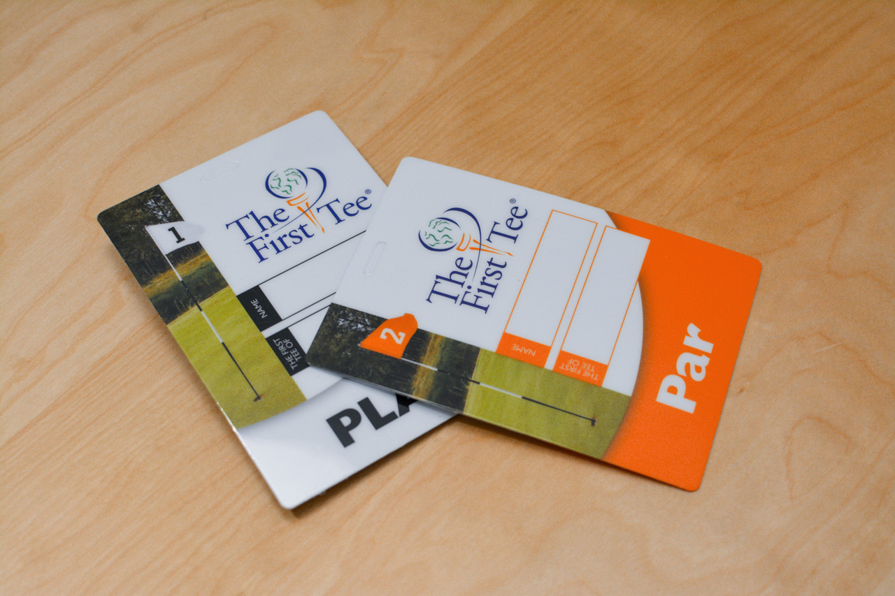 Three different custom plastic cards including a door hanger, an ID card, and a custom cut triangular key tag