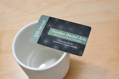 A shiny dental gift card with a patterned background