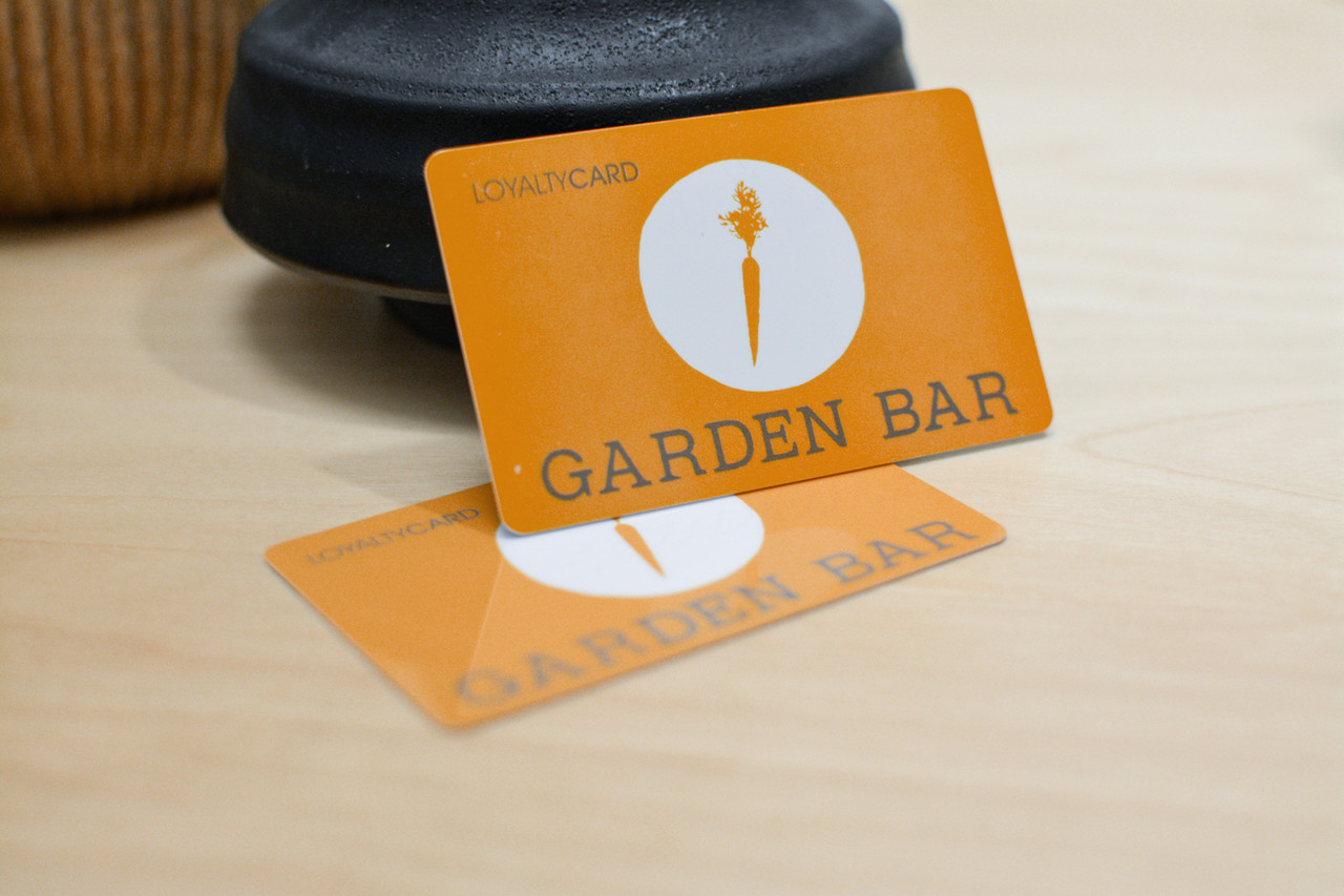 An orange card design with water drops and a vintage car logo