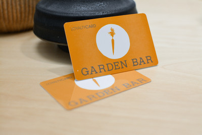 Orange cards with a carrot logo for a salad restaurant