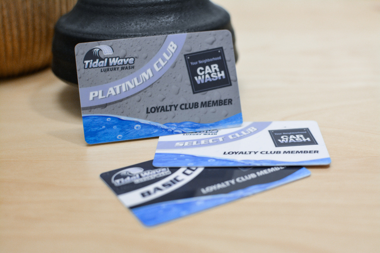 An orange card design with water drops and a vintage car logo