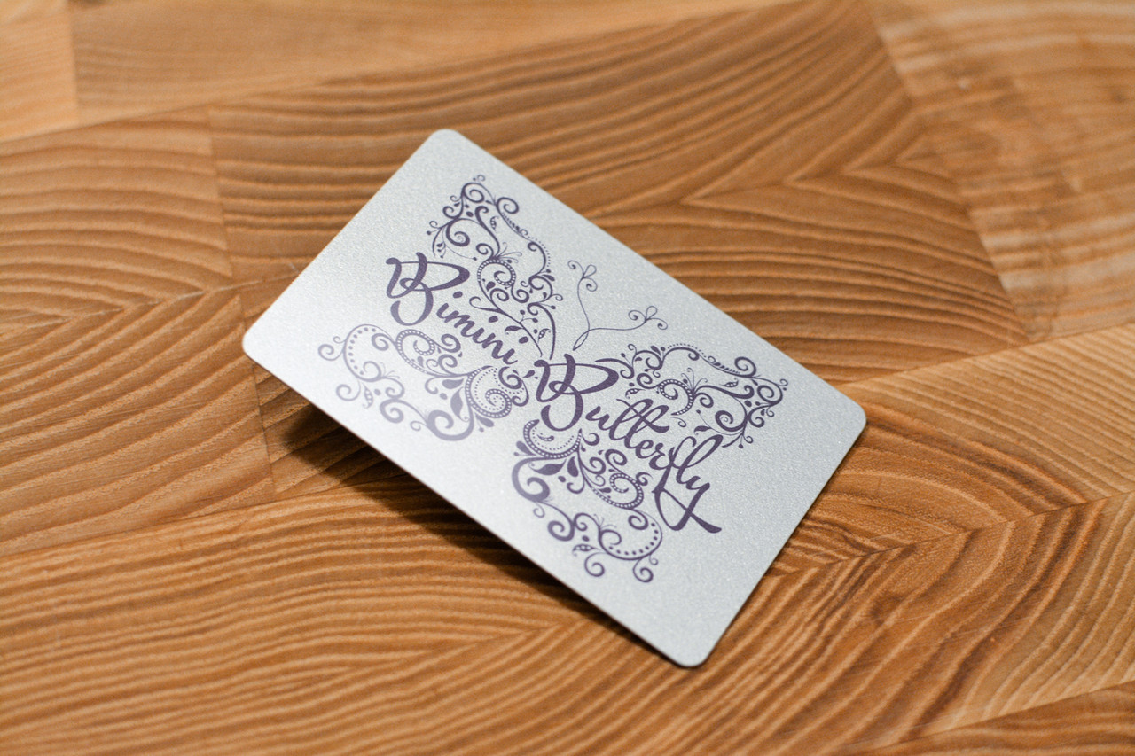 A hand-drawn card design with a reflective silver background