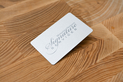A subtle metallic card design with a simple script logo