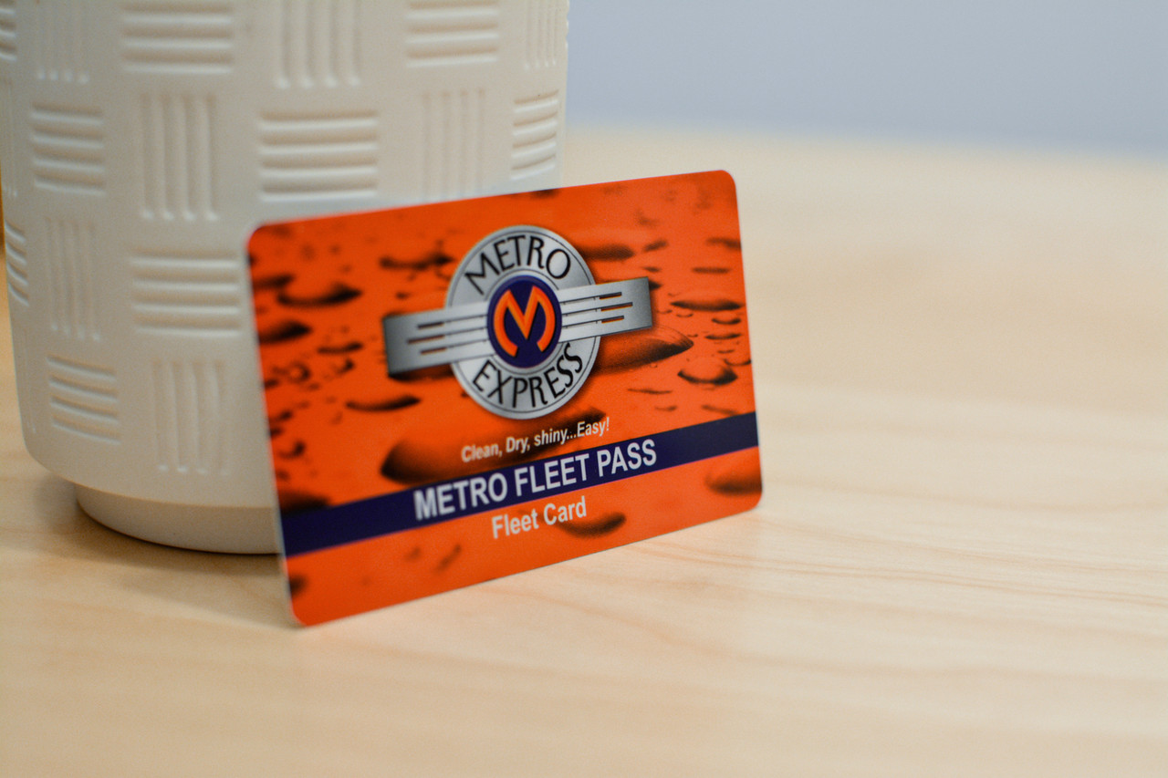 An orange card design with water drops and a vintage car logo